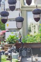 hanging bird feeders in shape of acorn full of different grain in the city photo