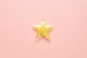 Minimalism concept with yellow star on pink background, top view, copy space. photo