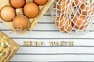 Zero waste Easter concept. No plastic bag concept. Minimal style. Beige mesh shopping bag with brown chicken eggs on textile background. photo