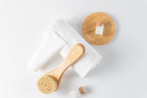 organic cosmetics, cream, sea salt, brush, and towel on a white background. The concept of spa and wellness. photo