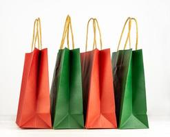 Set of craft paper shopping bags in christmas mood. on white background. Shopping concept for winter holidays. photo