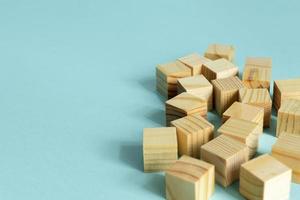 Construction of wooden cubes on blue background with copy space. Mockup composition for design photo