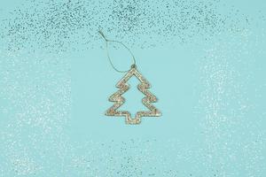 Frame with Christmas tree on blue background. Festive greeting card for new year. photo