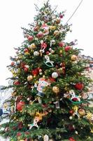 close up of christmas trees decoration with toys and garlands. City festive decor during winter holidays photo