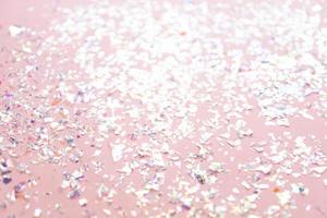 pearl confetti sparkles on pink holiday background. Festive backdrop of sparkles for birthday, carnival photo