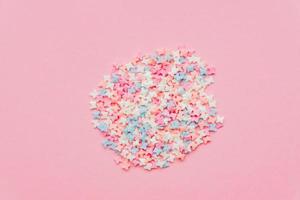 Sprinkle circle shape background. Sprinkle in the form of butterfly on pink background. copy space. top view photo