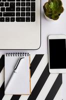 Simple Trendy Office Desk with notebook, eco craft office notepad and potted succulent. Home Office Desktop photo