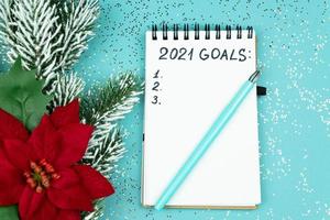 Notepad with handwrittrn 2021 goals for new year. Resolutions list. photo