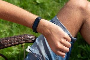 Close-up Of A Person Hand Wearing Smart Watch. fitness man using smart watch. photo