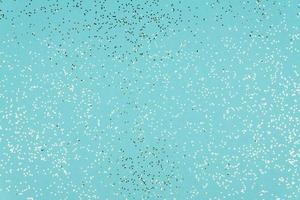 Blue Festive background texture with glittering silver confetti photo