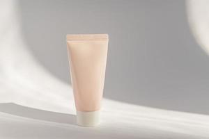 Pink cosmetic cream tube, balm jar mockup on white background. Make up product blank container. Body and face care photo