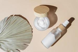 natural cosmetics with anti-aging, and anti-wrinkle effect on beige background. cream, mask in jar, serum, fluid, oil in bottle. face and body care concept photo