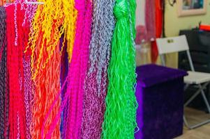 colorful strands of artificial hair for making African pigtails. photo
