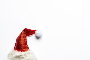 Red sparkling santa hat on whitw background with copy space. photo