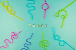 multicolored plastic cocktails straws on blue background photo