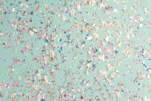 pearl confetti sparkles on blue holiday background. Festive backdrop or greeting card for designers. photo