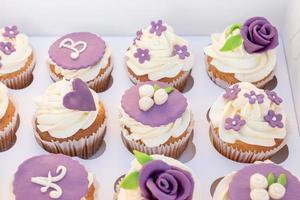 Set of different delicious cupcakes in a paper box for celebration photo