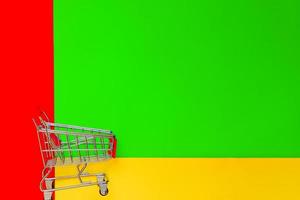 Top view of empty shopping trolley on colorful bright background. Concept of shopping and consumerism. Minimal flat lay. copy space. photo