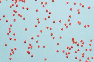 sprinkles background, sugar sprinkle red hearts, decoration for cake and bakery. Top view, flat lay. Valentines holiday photo