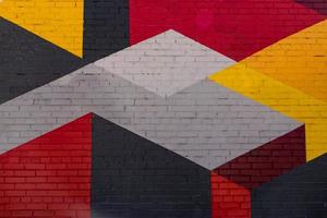 Colorful grey, red, yellow brick wall as background, texture photo