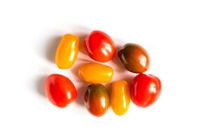 various colorful tomatoes on white background. Top view, flat lay. photo