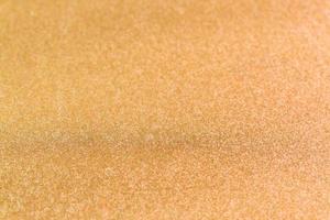 Abstract background texture with golden sparkling glitter. Festive backdrop for greeting cards and other design photo