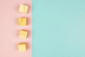 four wooden cubes on pink background. Creative flat lay with copy space. Mockup for design photo