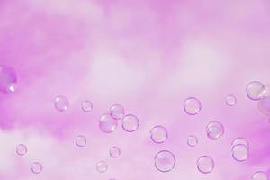 Abstract background, soap bubbles on pink sky background. Copy space for text. photo