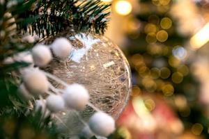 Christmas and New Year holidays background. Christmas tree decorated with white trnsparent ball. Celebration concept photo