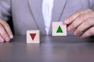 Wooden blocks with a red down arrow and a green up arrow. The process of successful business and economic development. Improving productivity, planning, management and strategy. photo