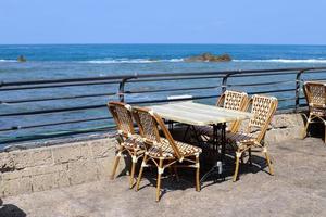 A chair in a city park on the seashore. photo