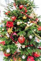 close up of christmas trees decoration with toys and garlands. City festive decor during winter holidays photo