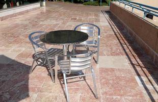 A chair in a city park on the seashore. photo