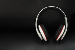 Bluetooth headphones on black leather background photo