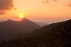 puesta de sol de silueta sobre las montañas en nan, tailandia foto