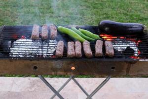 Vegetables and meat are fried on the grill. photo