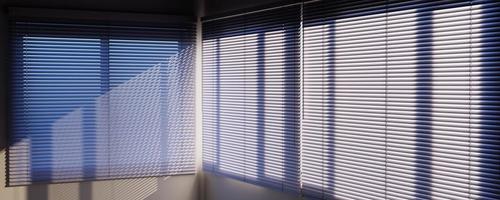 Panoramic view of White Venetian blinds with sunlight and shadow. Window blinds. 3d rendering. photo