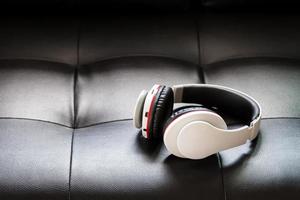 Bluetooth headphones on black leather background photo