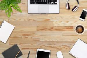 Modern workspace with laptop tablet, smartphone and coffee cup copy space on color background. Top view. Flat lay style. photo