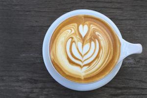 latte art coffee on wood background photo