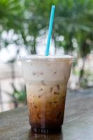 Iced coffee latte in takeaway cup on nature bokeh photo