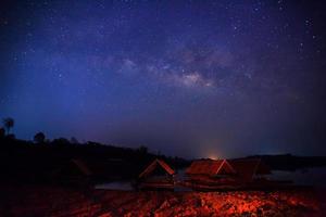 Silhouette of Floating house and Milky Way. Long exposure photograph. photo