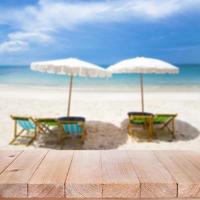 Wood table top on blurred blue sea and white sand beach background photo