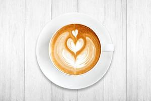 Top view latte art coffee on wood background photo