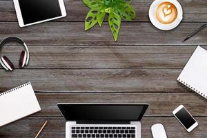 Modern workspace with laptop tablet, smartphone and coffee cup copy space on color background. Top view. Flat lay style. photo