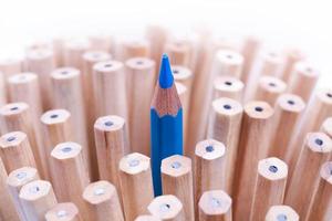 One sharpened blue pencil among many ones photo