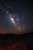 Milky way galaxy with stars over moutain at Phu Hin Rong Kla National Park,Phitsanulok Thailand, Long exposure photograph.with grain photo