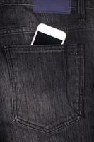 white mobile phone in pocket with black screen photo