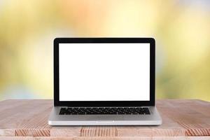 Front view of the laptop is on the work table with bokeh green background photo