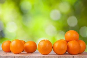 Fresh orange on wood with blur bokeh background photo